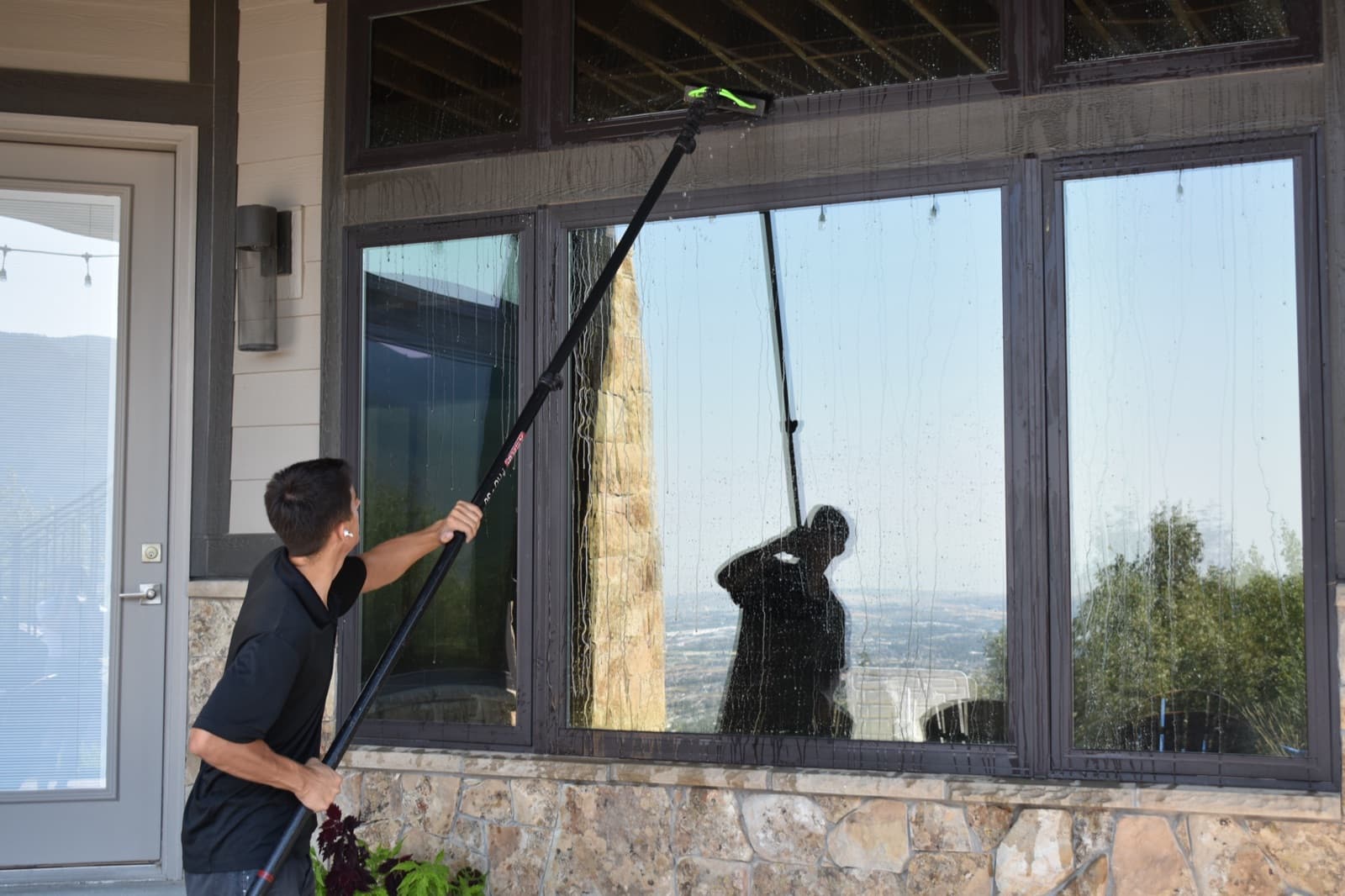 Freshly cleaned picture windows reflecting a Utah mountain valley