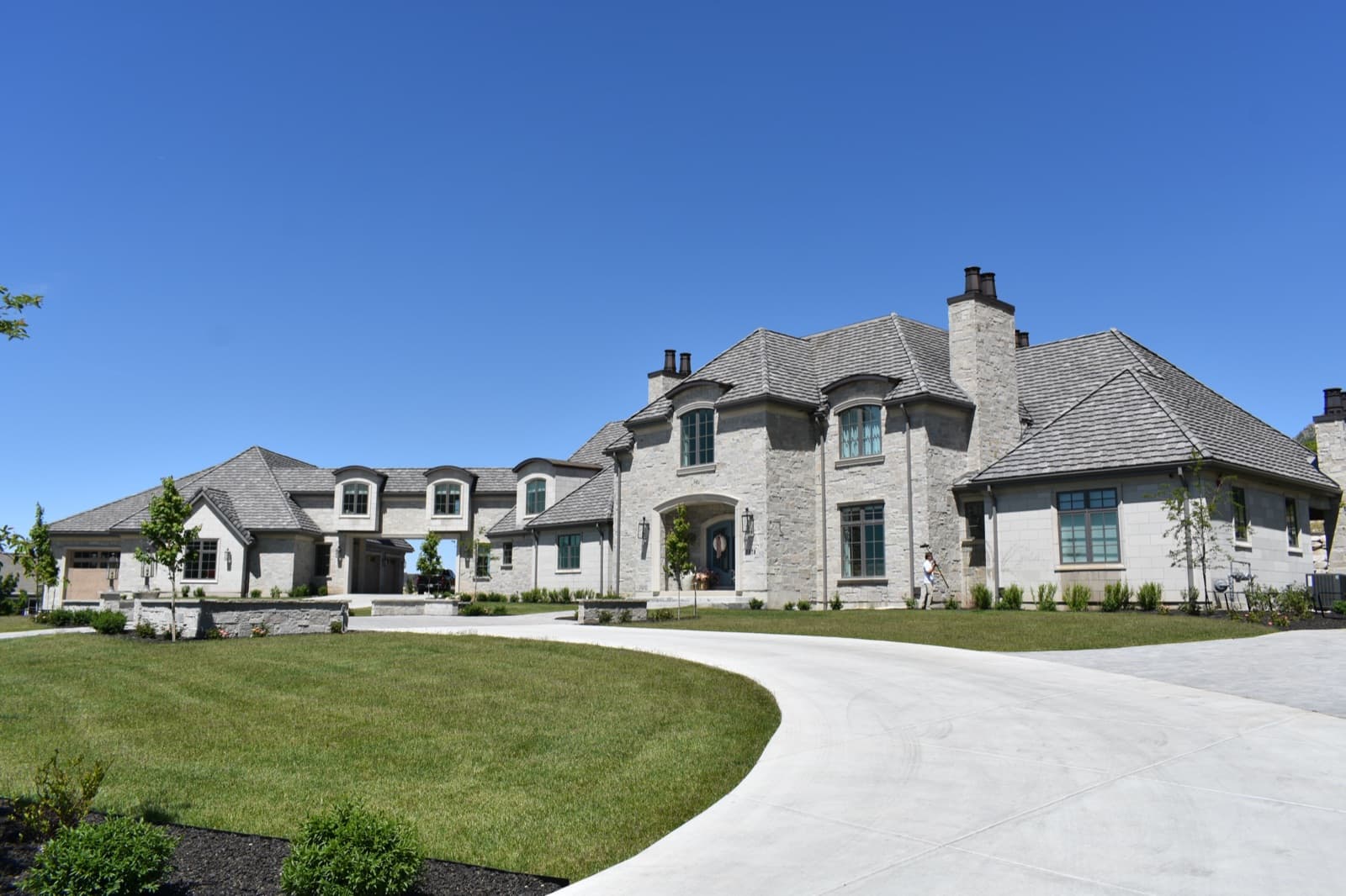 Sprawling stone estate with clean windows and circular driveway in Northern Utah