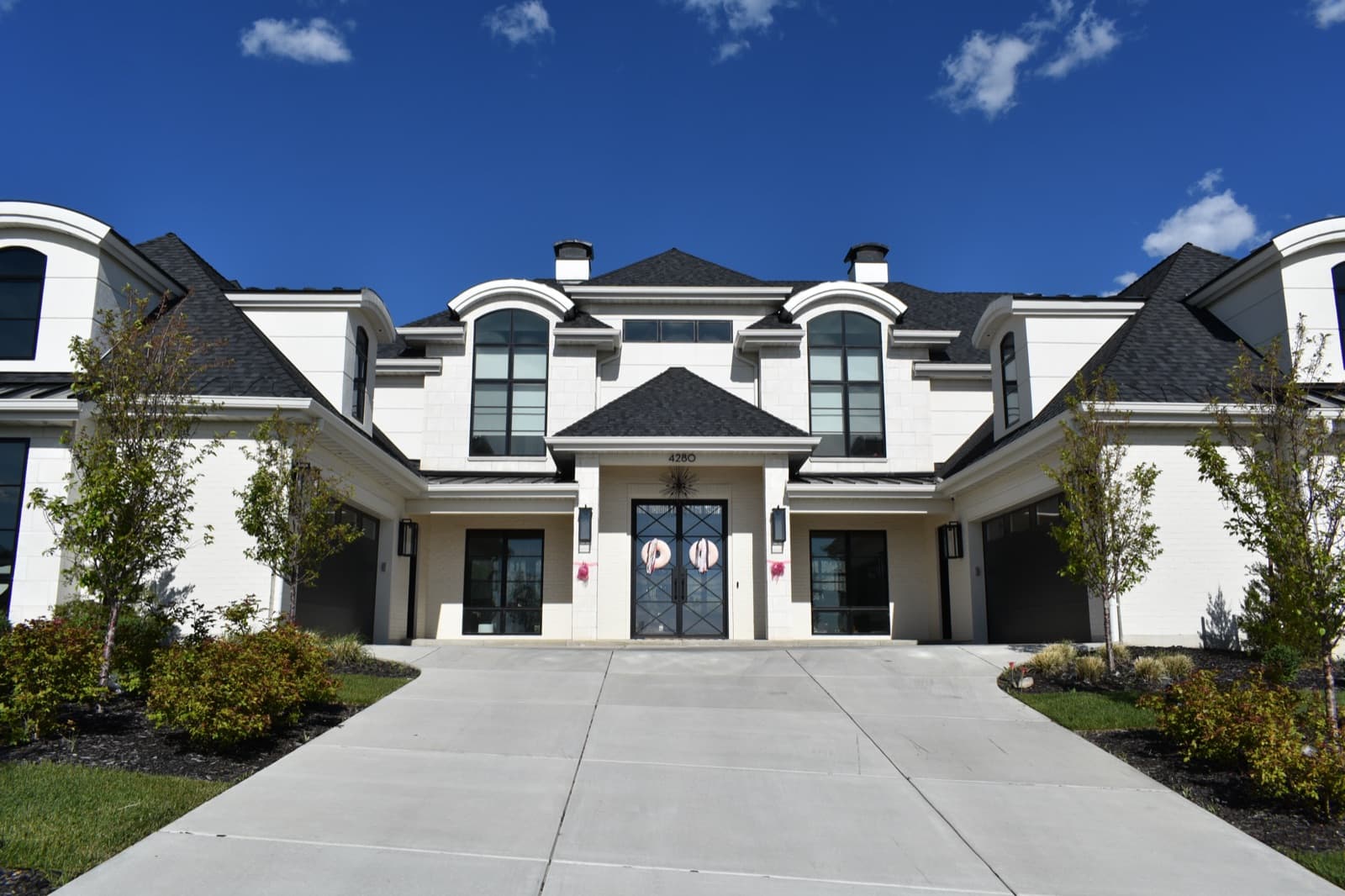 Luxury white home with freshly cleaned windows under a deep blue sky in Northern Utah
